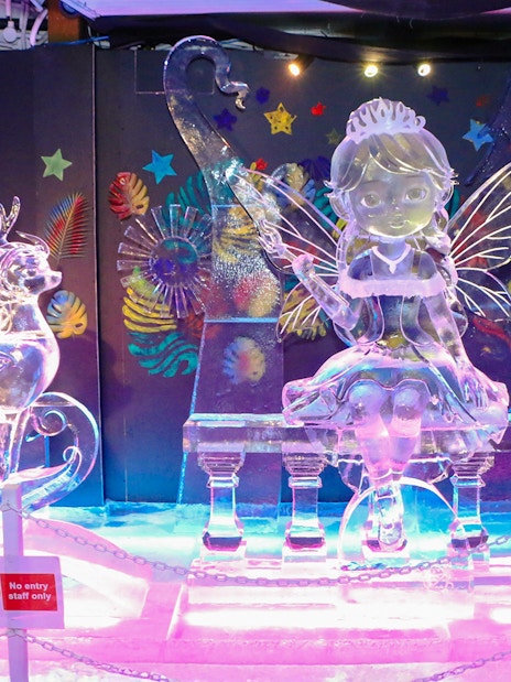 Ice sculptures of a fairy and reindeer at The Rainbow Frosty Playground, Singapore Snow City.