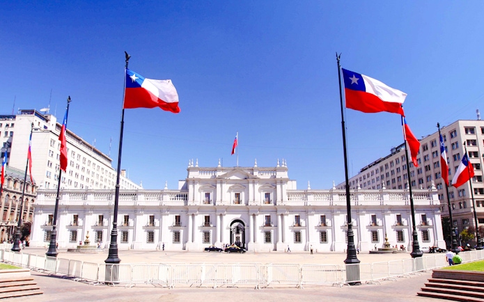 La Moneda Palace in Santiago with Chilean flags.