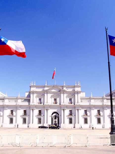 La Moneda Palace in Santiago with Chilean flags.