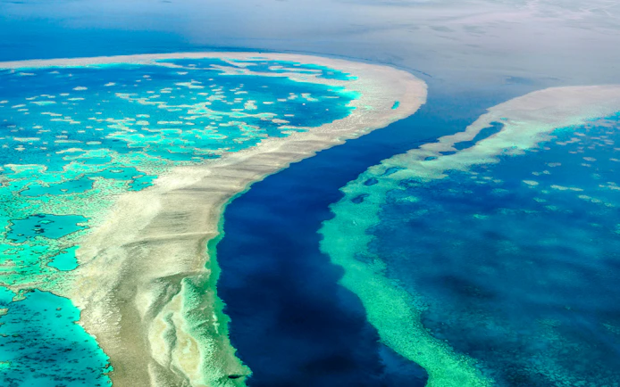 Aerial view of the Great Barrier Reef's vibrant coral formations in Whitsundays, Australia.