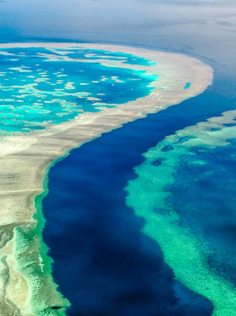 Aerial view of the Great Barrier Reef's vibrant coral formations in Whitsundays, Australia.