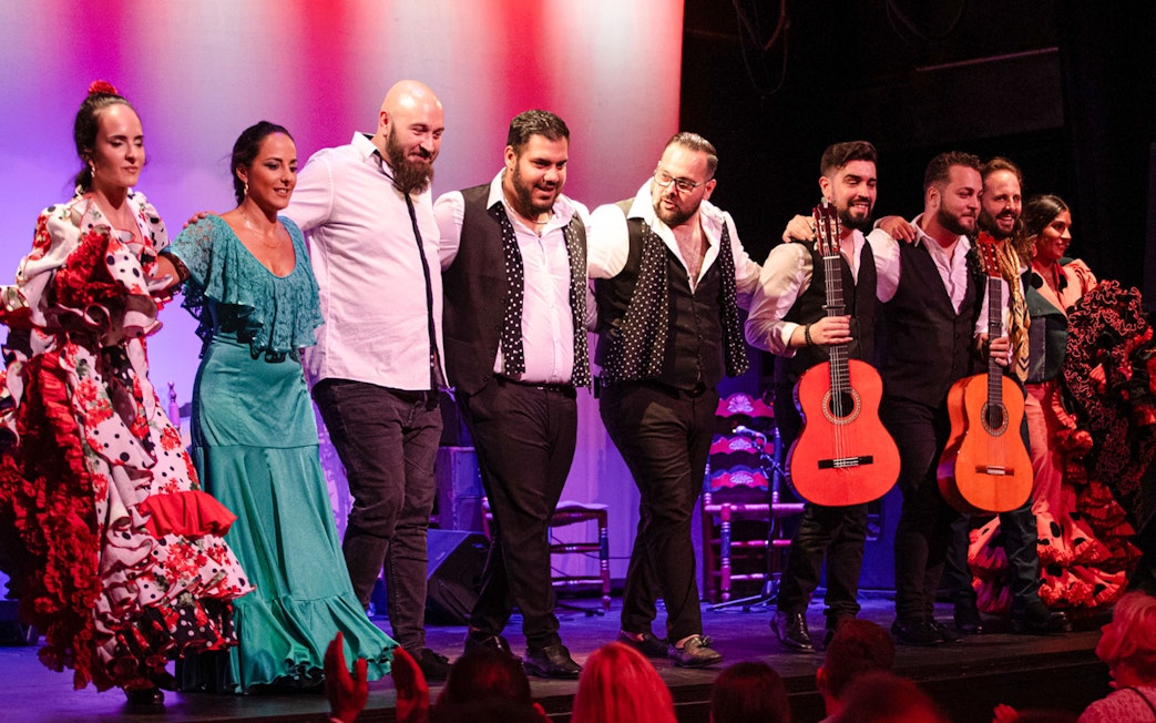 Flamenco performers taking a bow on stage in Barcelona.