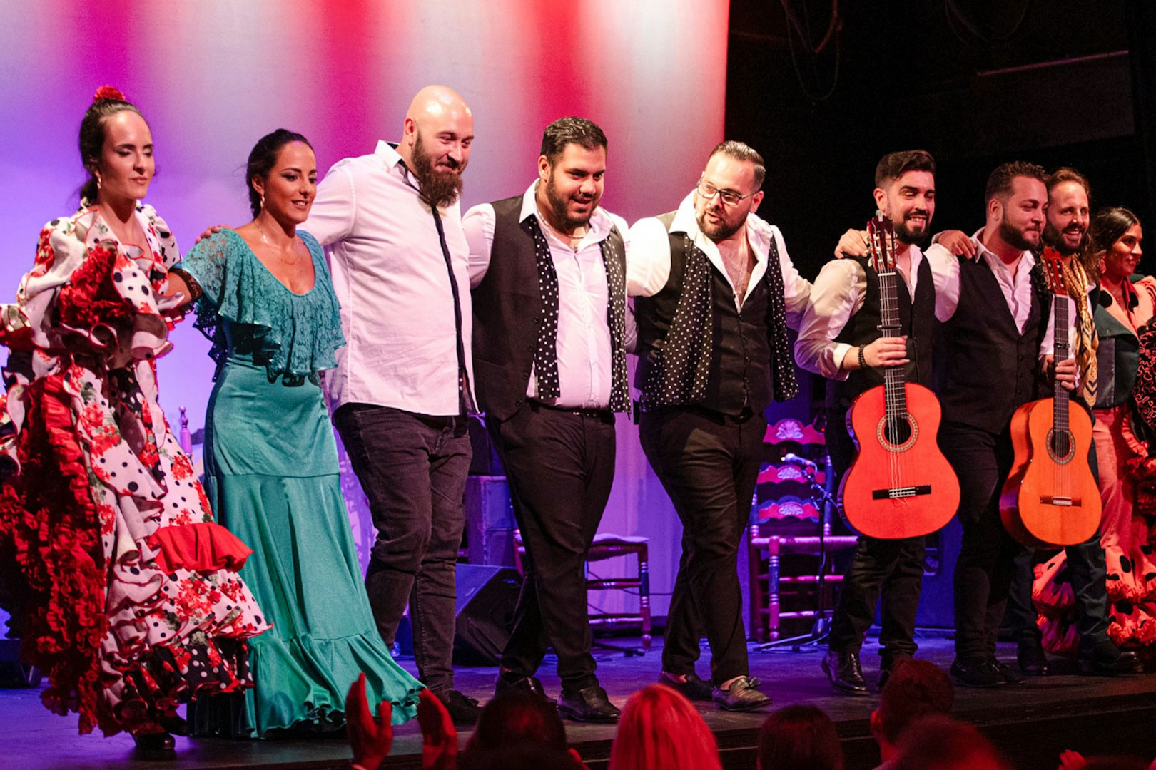 Flamenco performers taking a bow on stage in Barcelona.