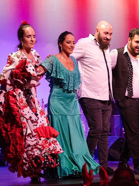 Flamenco performers taking a bow on stage in Barcelona.