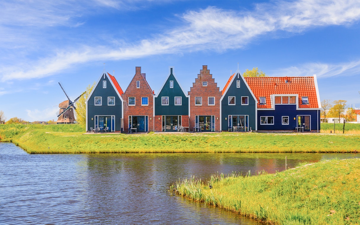 Traditional Dutch houses and windmill in Zaanse Schans, Netherlands.