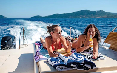 Boat ride with friends enjoying drinks, Dubrovnik, Croatia.