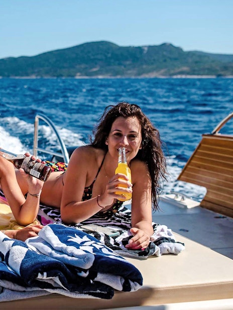Boat ride with friends enjoying drinks, Dubrovnik, Croatia.