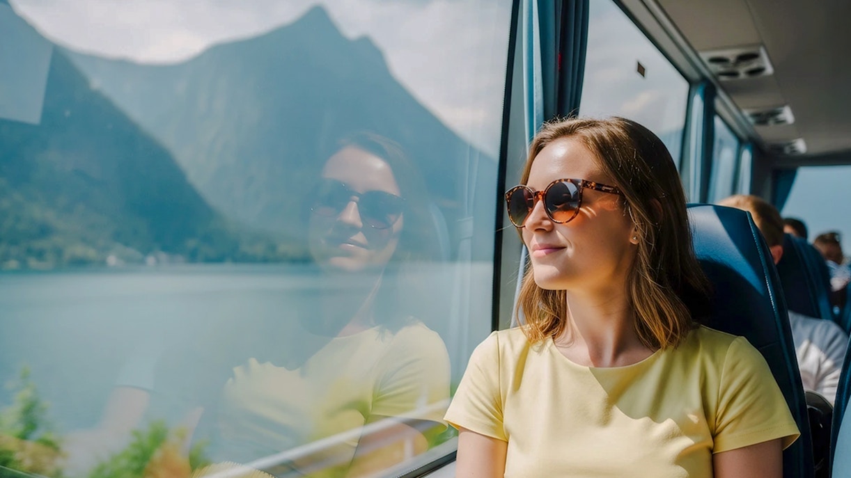 Passenger enjoying scenic view from AC coach, Hallstatt.