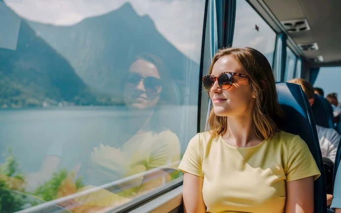 Passenger enjoying scenic view from AC coach, Hallstatt.