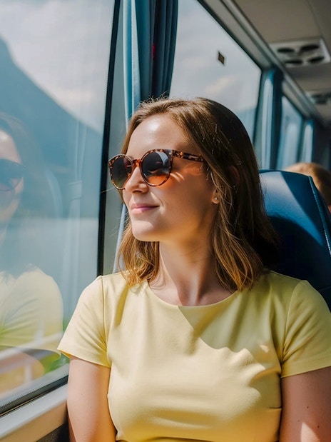 Passenger enjoying scenic view from AC coach, Hallstatt.