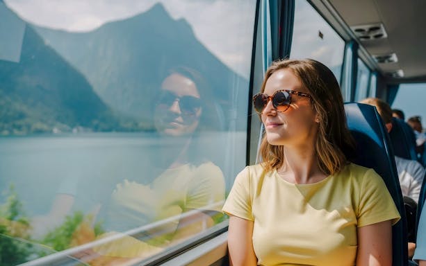 Passenger enjoying scenic view from AC coach, Hallstatt.