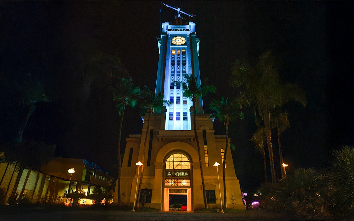 Aloha Tower illuminated at night, Moana Luau, Hawaii.