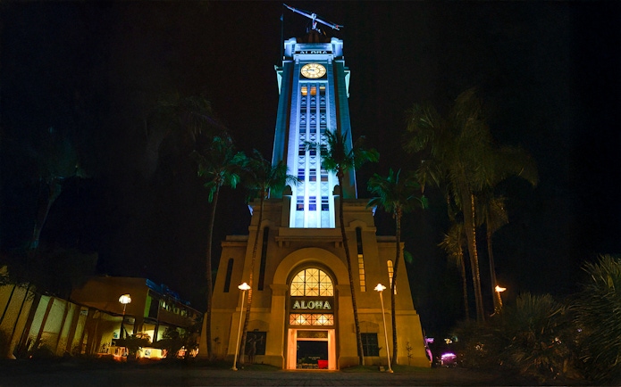 Aloha Tower illuminated at night, Moana Luau, Hawaii.