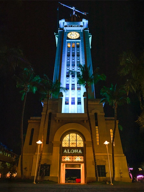 Aloha Tower illuminated at night, Moana Luau, Hawaii.