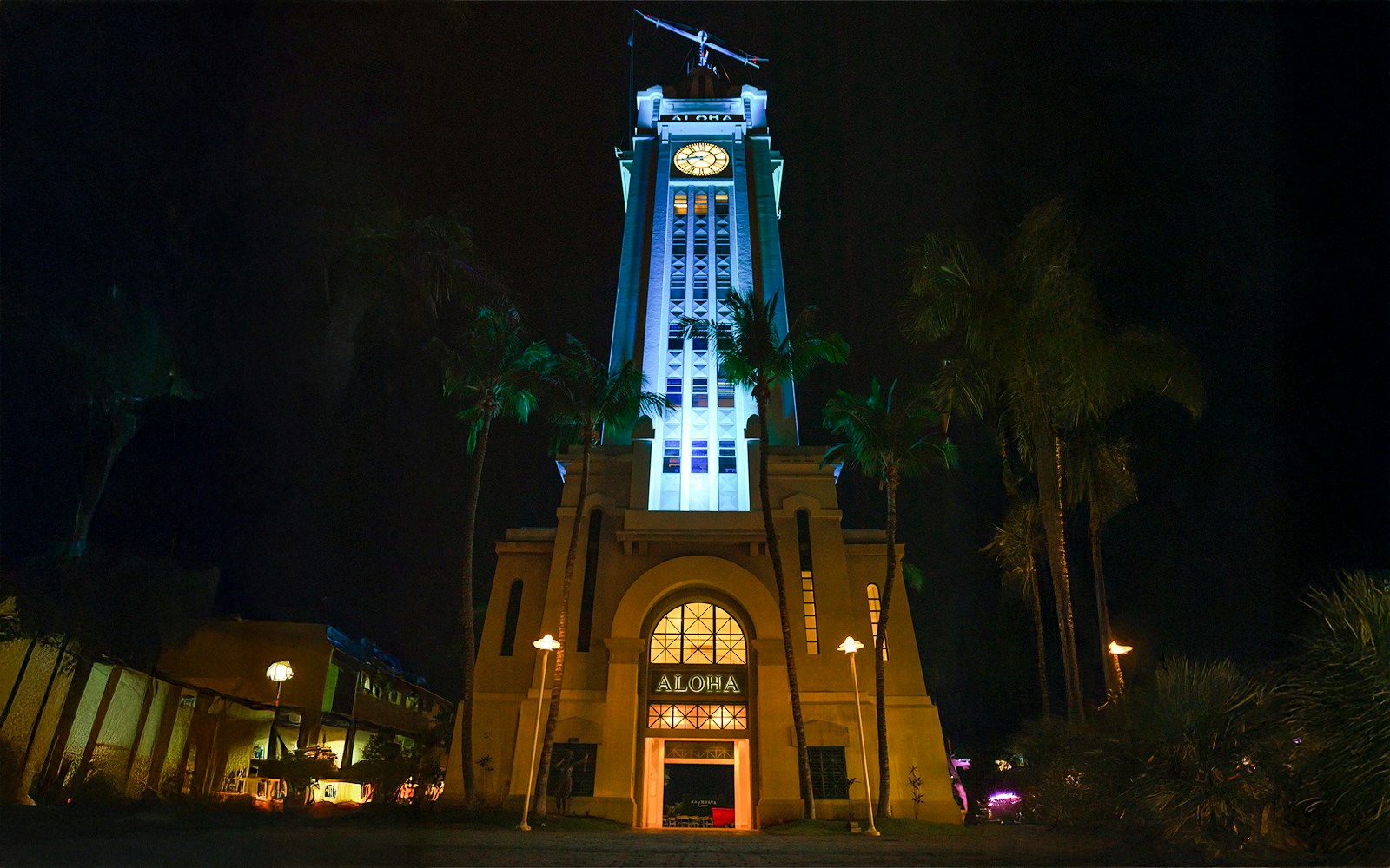 Aloha Tower illuminated at night, Moana Luau, Hawaii.