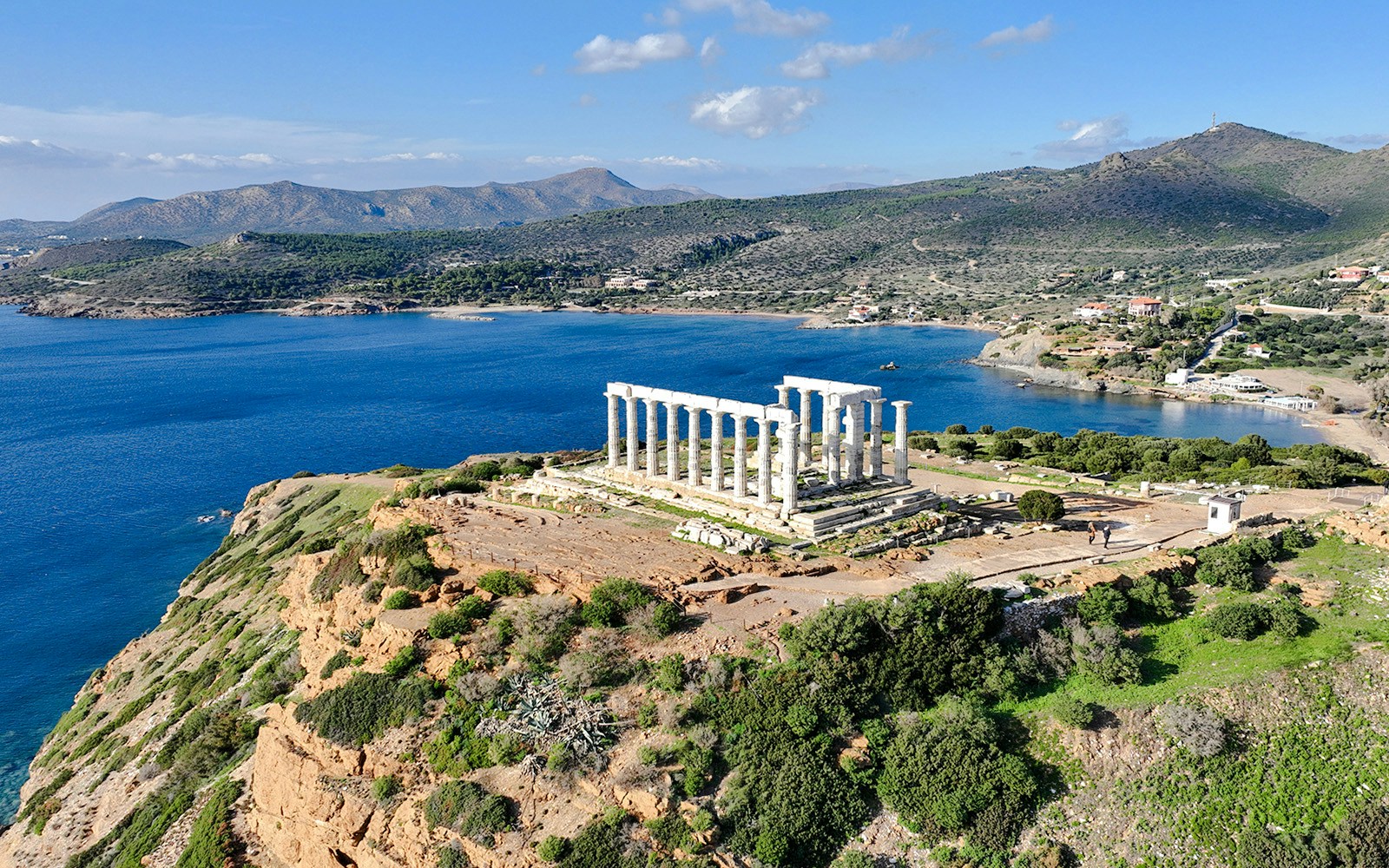Aerial view of the Temple of Poseidon at Cape Sounio, Greece, overlooking the Aegean Sea.