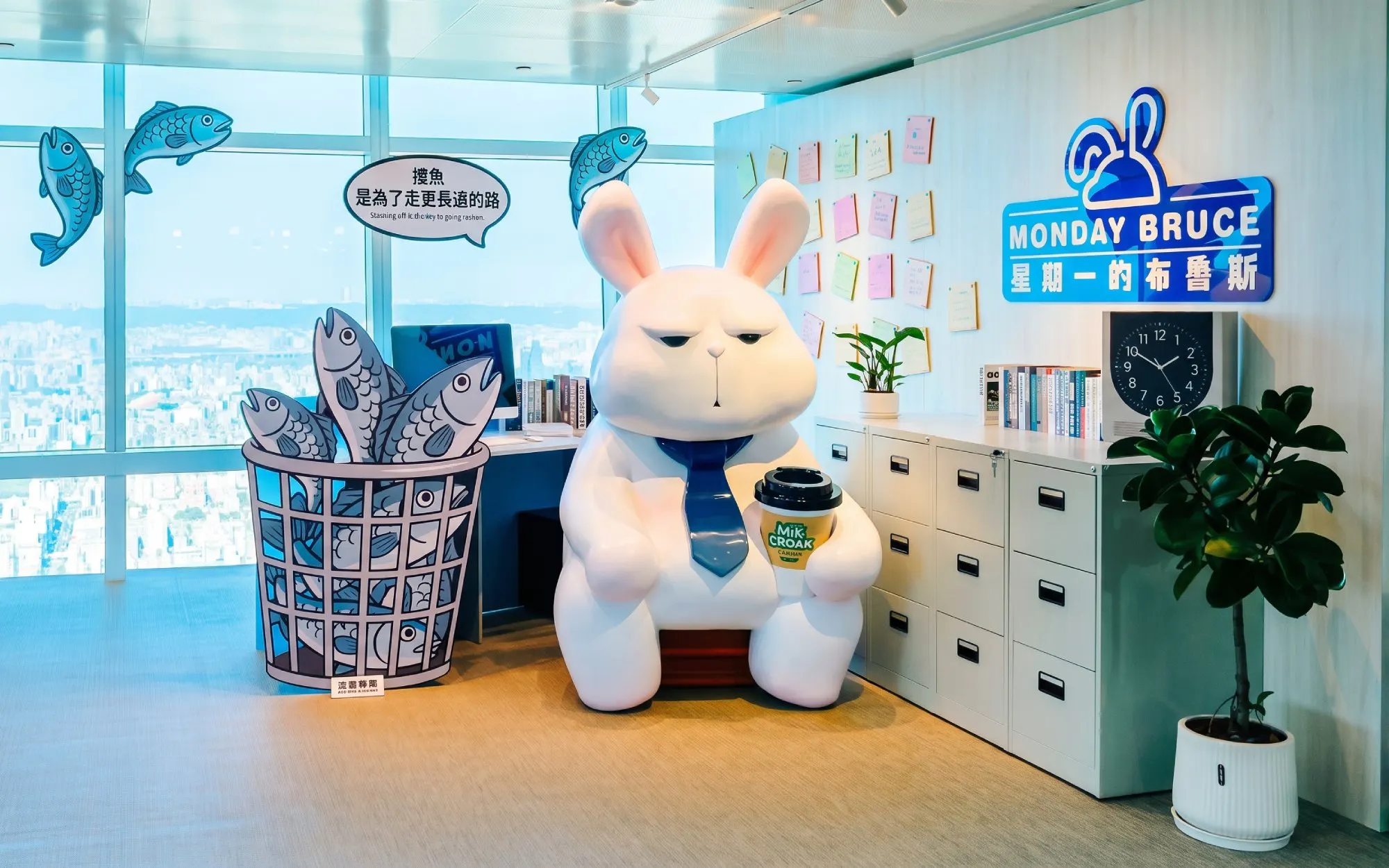 Cartoon rabbit statue with coffee cup at Taipei 101 Observatory office display.