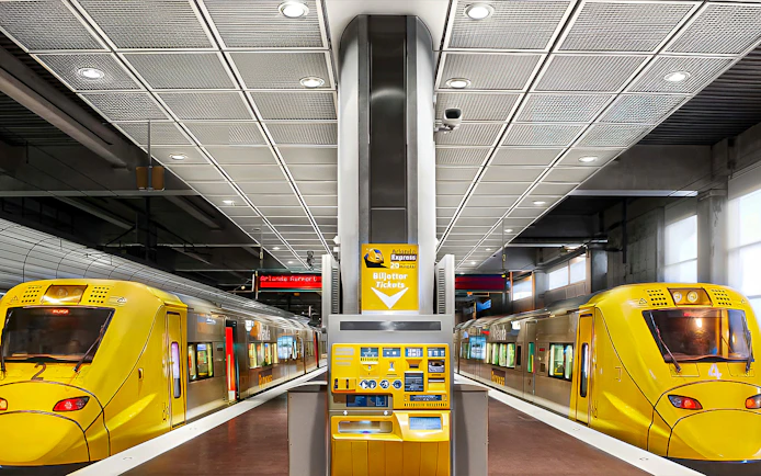 Stockholm Arlanda Express trains at underground station platform with ticket machine.