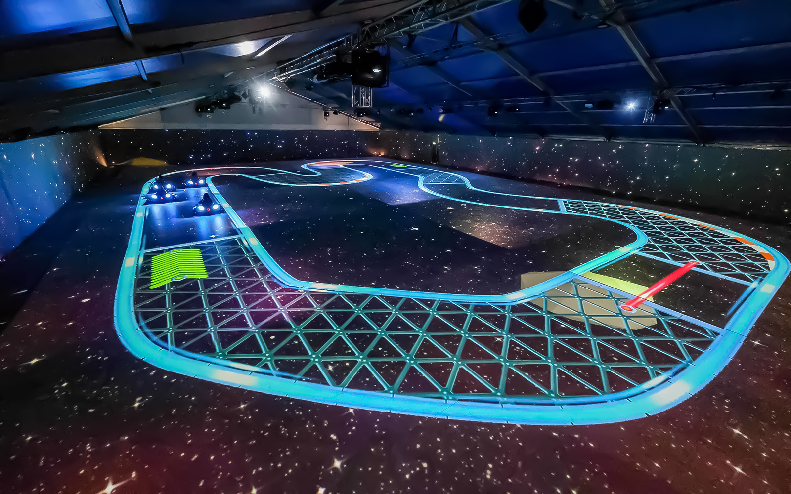 Immersive karting track with neon lights at Chaos Karts Dubai.