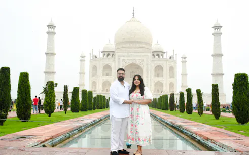 Couple standing in front of the Taj Mahal, Agra, during a private guided tour.