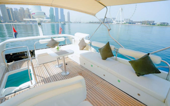 Luxury yacht deck with Dubai skyline and Ferris wheel in the background.