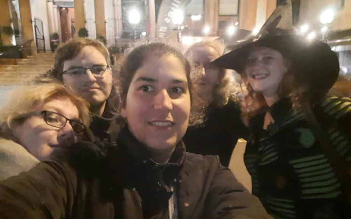 Group enjoying Ghosts of Belfast self-guided city exploration game at night.
