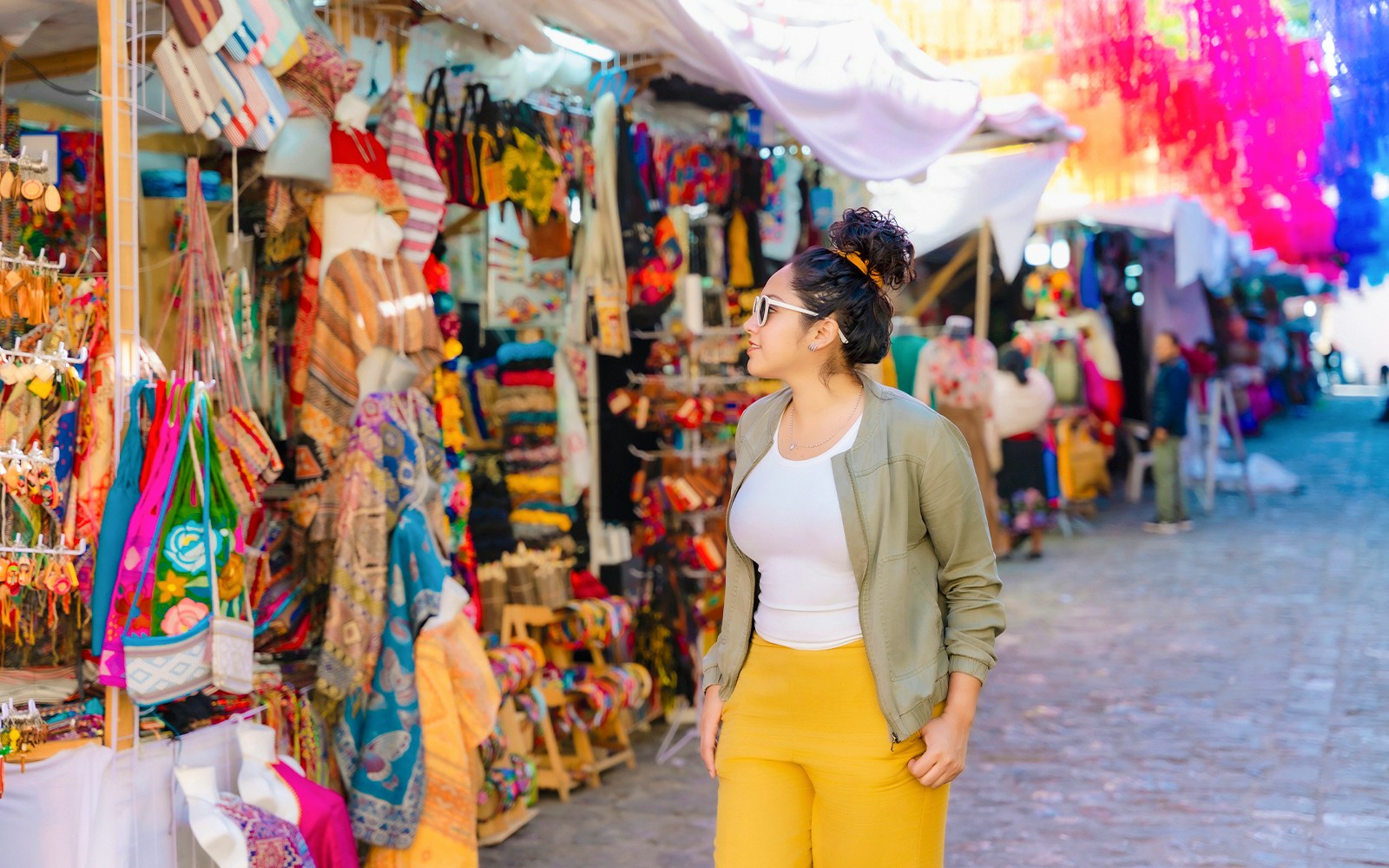 Tourist browsing colorful street market in Mexico.
