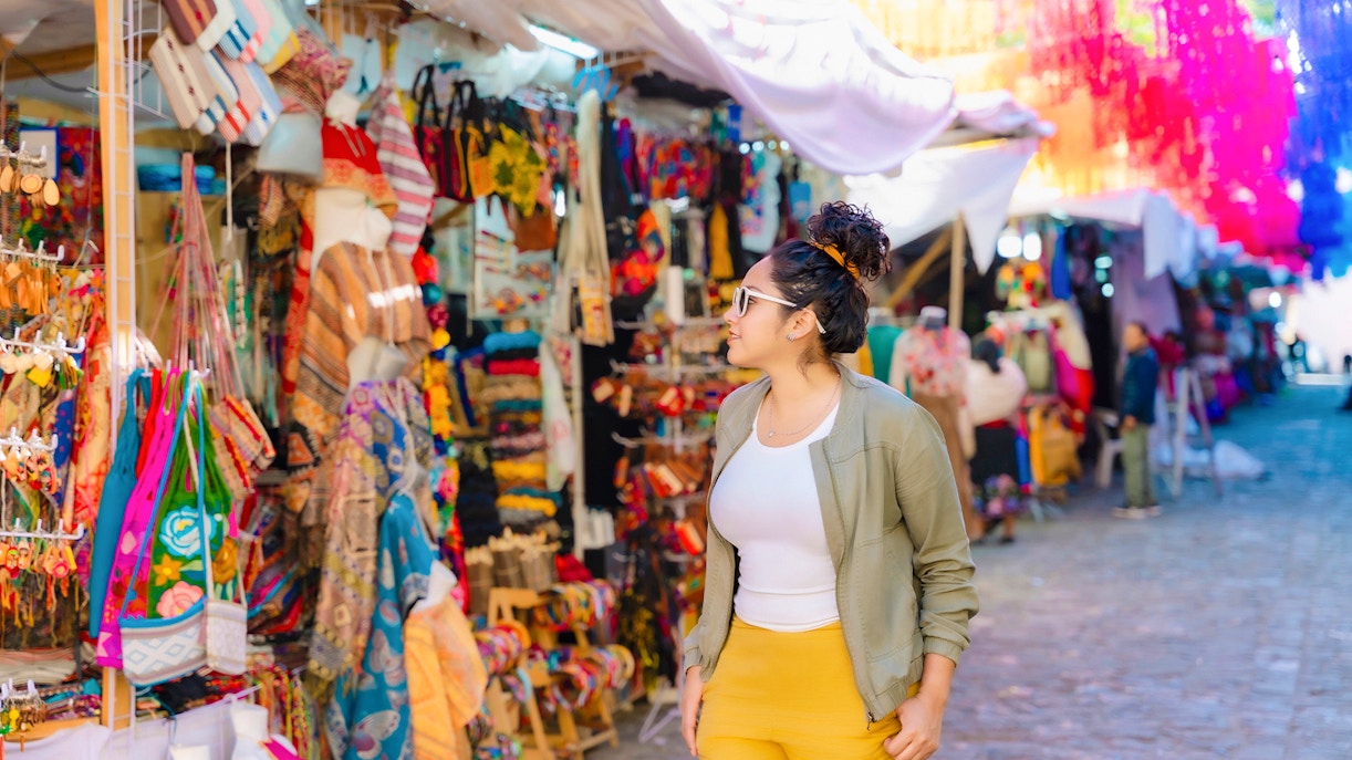 Tourist browsing colorful street market in Mexico.