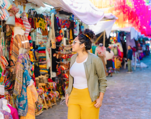 Tourist browsing colorful street market in Mexico.