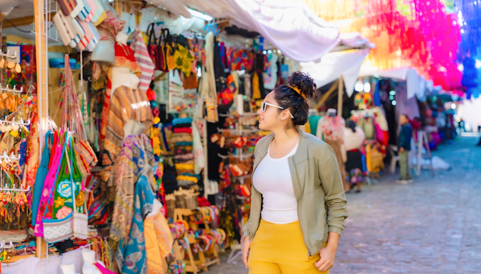 Tourist browsing colorful street market in Mexico.