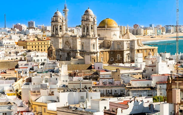 Cádiz Cathedral with cityscape and ocean view on a day trip from Seville.