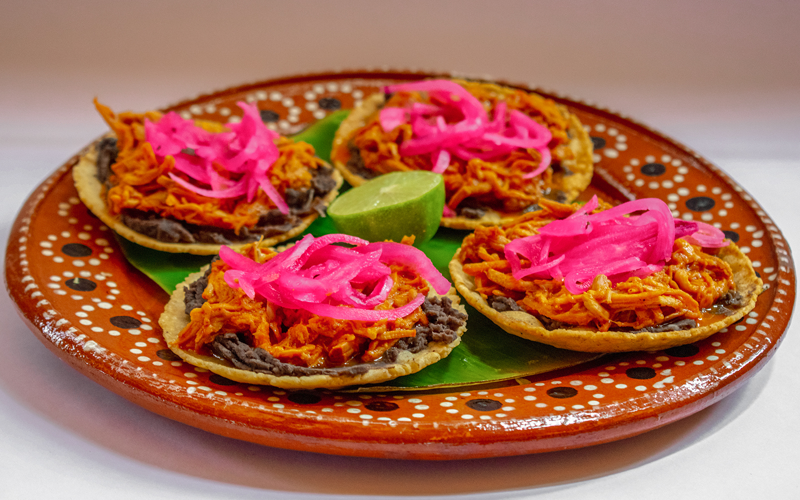 Cochinita Pibil Panuchos served on a plate in Yucatan, Mexico.