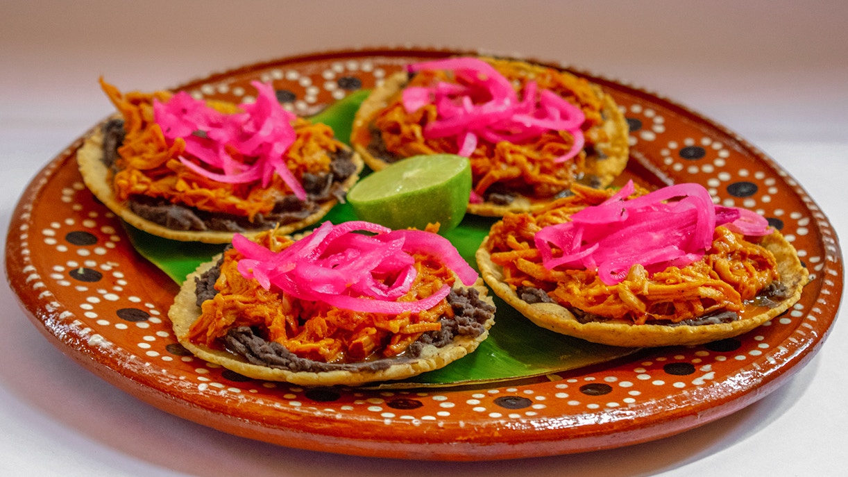 Cochinita Pibil Panuchos served on a plate in Yucatan, Mexico.