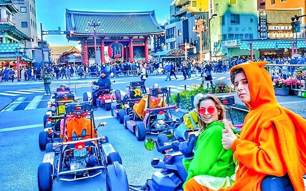 People in costume driving go-karts near Senso-ji Temple, Tokyo.
