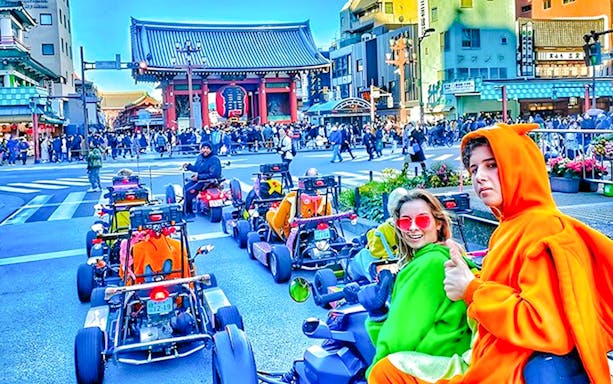 People in costume driving go-karts near Senso-ji Temple, Tokyo.