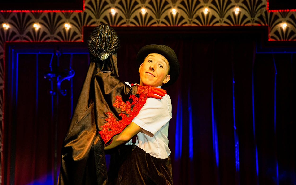 Performer in costume dancing at Golden Years Show Café.