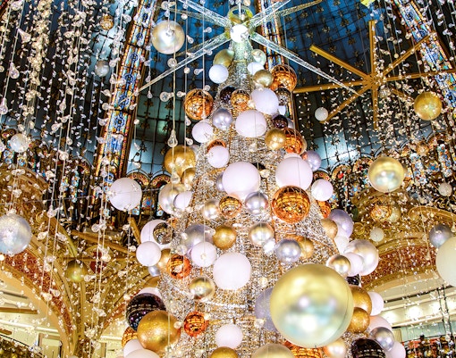Stained glass dome and festive decorations at Galeries Lafayette, Paris.