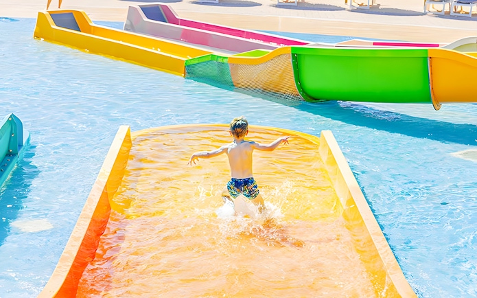 Child sliding down Mini Rio Rapido water slide at Aquopolis.