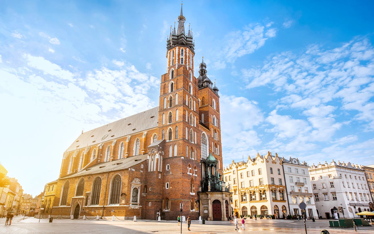 St Mary's Basilica in Krakow at sunrise with clear blue sky.