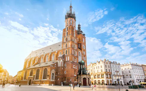 St Mary's Basilica in Krakow at sunrise with clear blue sky.