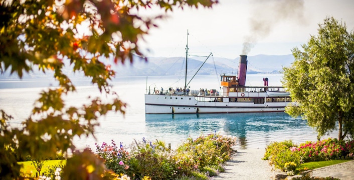 TSS Earnslaw steamboat approaching Walter Peak High Country Farm on Lake Wakatipu