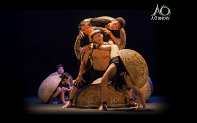 Performers balancing on woven baskets during traditional AO show.