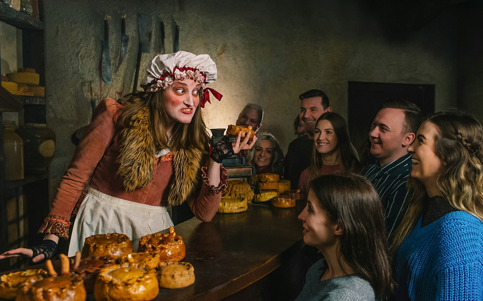 Costumed actor engaging visitors at London Dungeon experience.