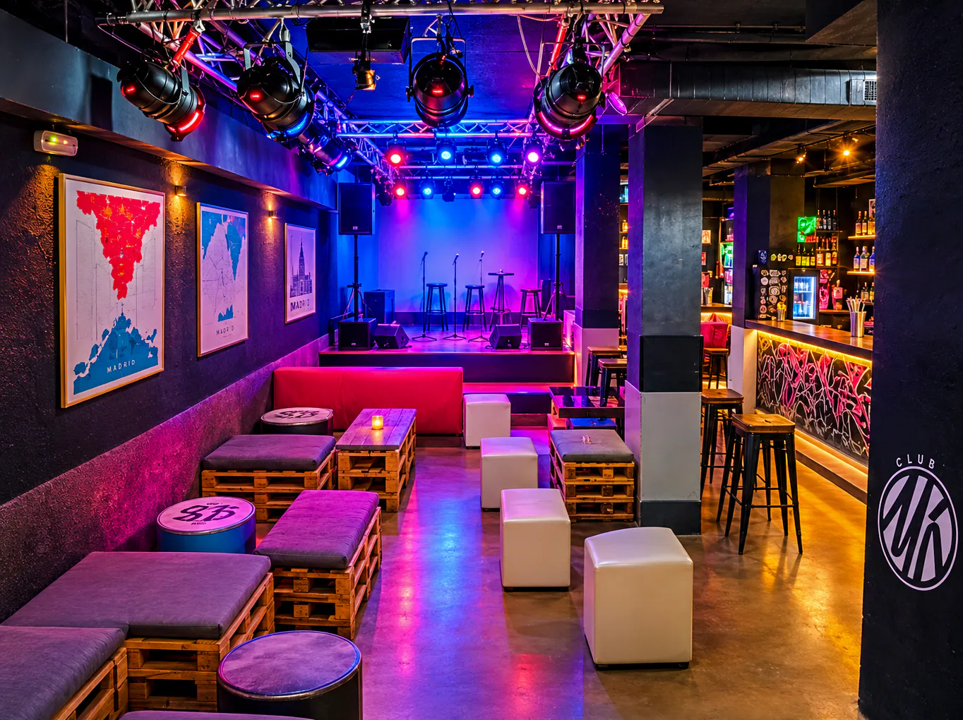 Nightclub interior with colorful lights, stage, and seating in Tangier.