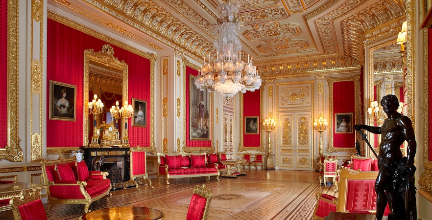 Crimson Drawing Room with ornate gold decor and chandeliers, Windsor Castle.