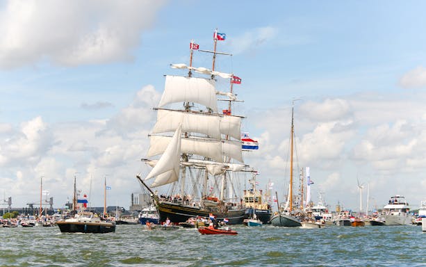 Tall ships sailing in Amsterdam harbor during SAIL Amsterdam event.