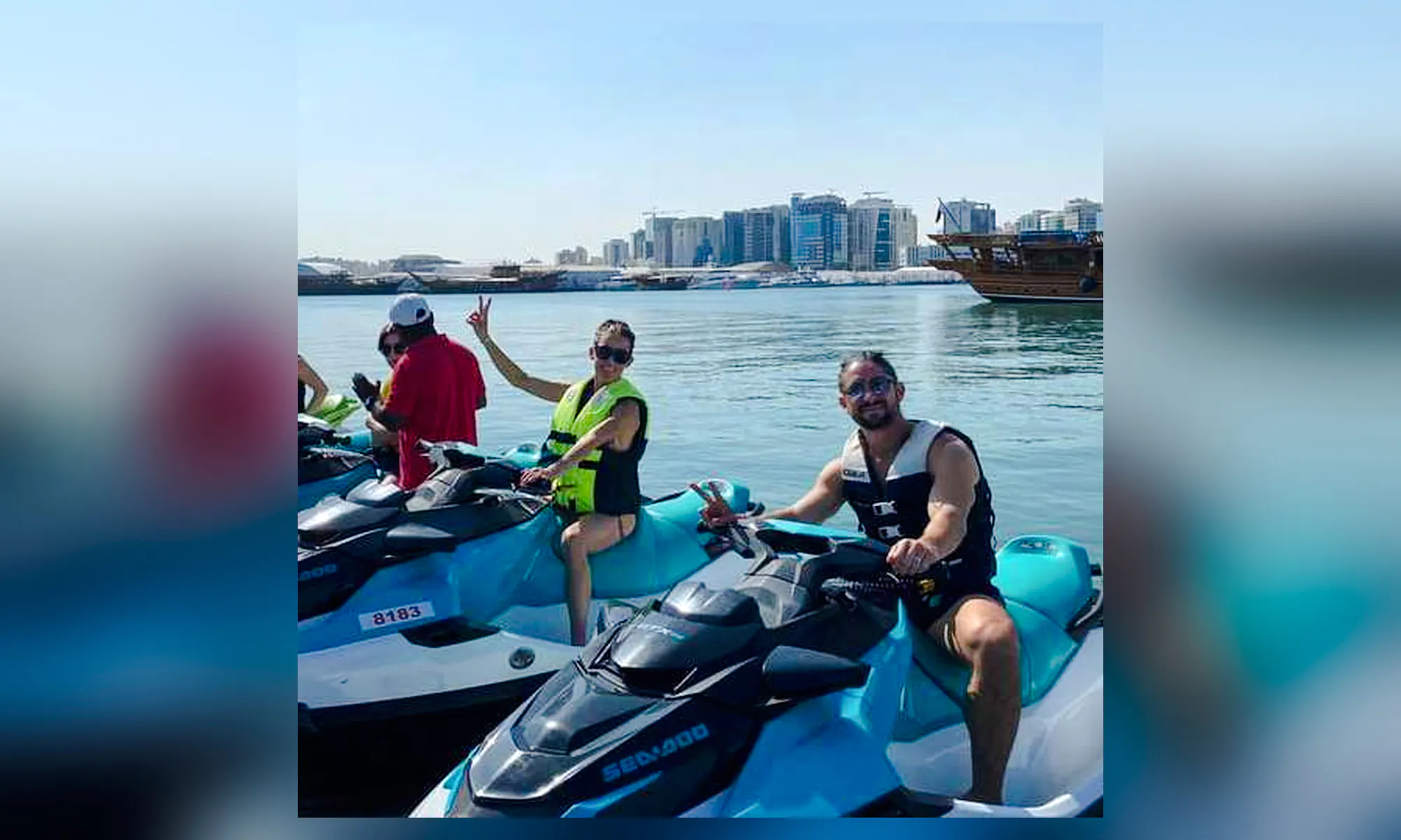 Jet skiers enjoying a ride with Doha skyline in the background, Qatar.