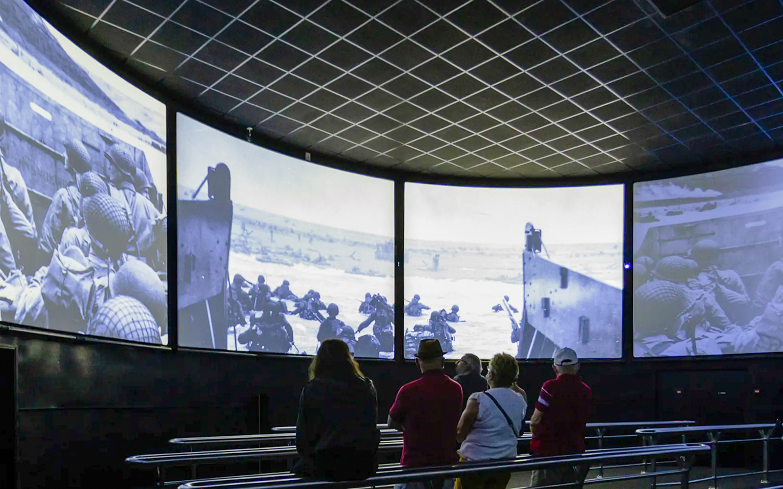Visitors watching D-Day footage inside Arromanches 360 Circular Cinema, France.