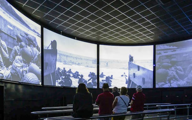 Visitors watching D-Day footage inside Arromanches 360 Circular Cinema, France.