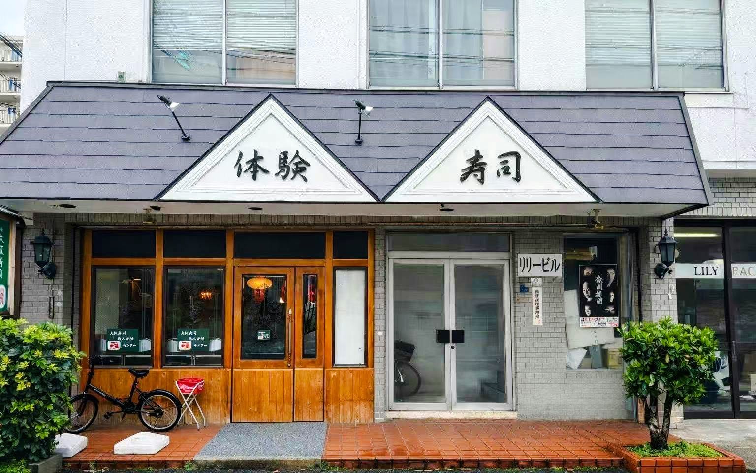 Exterior of sushi workshop venue in Osaka with traditional signage.